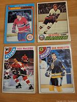 Four hockey cards front side: Doug Jarvis (Montreal Canadiens), Bob Nystrom (New York Islanders), Rick MacLeish (Philadelphia Flyers), Don Marcotte (Boston Bruins).
