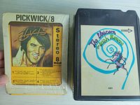Photo shows Elvis Presley cassette cartridge with Pickwick branding and The Irish Rovers cassette with spiral unicorn logo.