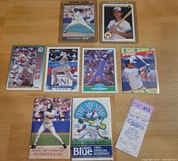 Photo of several baseball cards including Juan Guzman and John Olerud rookie cards, other players, two Toronto Blue Jays schedules from 1990 and 1991, and a game ticket stub.