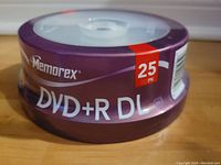 Photo of Memorex 25 pack blank DVD+R DL discs in original spindle packaging with purple and white design.