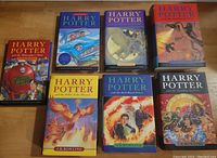 Top down view of all 7 books laid flat with front covers visible.