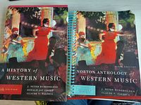 Front covers of the two books showing artwork and titles: 'A History of Western Music' and 'Norton Anthology of Western Music' Ancient to Baroque workbook.