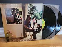 Photo of Pink Floyd Ummagumma album cover with two black vinyl records partially pulled out from sleeve.