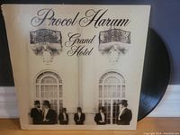 Front cover of Procol Harum Grand Hotel vinyl album showing band name and artwork with members in formal wear and top hats.