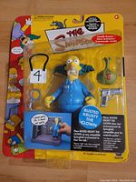 Front view of unopened Krusty the Clown action figure in blister packaging showing figure and accessories