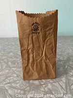 Front view showing crinkled paper-bag texture and printed Harvey Craft Associates logo