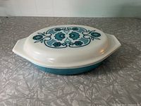 View of Pyrex casserole dish with lid on, showing the Horizon Blue floral pattern on lid and solid blue base.