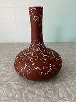Front view of the vintage Beauceware ceramic vase on a tiled background.