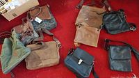 Main overview photo showing all six purses and satchels laid out on red carpet