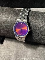 Front view of Fossil women's watch showing purple gradient dial and single crystal marker at 12 o'clock.