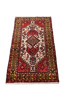 Full view of the rectangular Karaja rug showing intricate border and central diamond design in red, cream, yellow, and black colors.