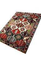 Full view of rug laid flat showing geometric medallion pattern in multiple colors