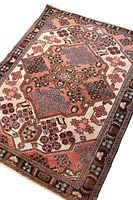 Top angle showing full rug with central medallion and border design, highlighting the floral and geometric motifs and muted natural colors.