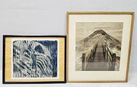 Two framed artworks side by side: a woodcut print of a pier and mountain, and an abstract geometric pattern print.