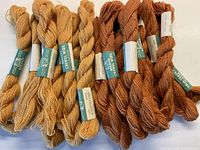 20 skeins of crewel wool yarn in two cinnamon shades, showing full lot