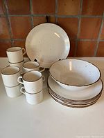 Full group shot showing plates, cups, saucers and bowls