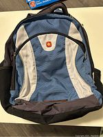 Front view of blue and gray SwissGear backpack showing multiple compartments and SwissGear logo