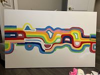 Photo showing the full front view of the large abstract painting with rainbow-colored interconnected lines on white canvas.