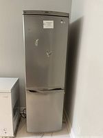 Closed stainless steel LG refrigerator showing full height and bottom freezer drawer.