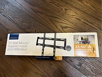 Photo of the boxed Insignia TV Wall Mount showing the brand, size compatibility (33-46 inches), and fixed position feature.