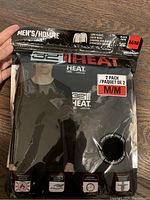 Two-pack men's long sleeve thermal shirts in original sealed packaging.