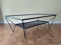 Angled full view of coffee table on wood floor against wall