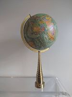 Front view of globe showing Africa and Europe on stepped metal base