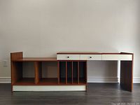 Full view of teak record stand in extended position showing two-piece adjustable width design, record slots and drawers