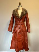 Front view of leather coat on dress form