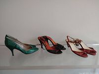 Three pairs of women's leather shoes shown from side and front angles.