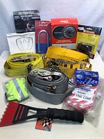 Full lot showing multiple automotive items including tie down straps, lockout tags, gloves, ice scraper, and boxes of accessories.