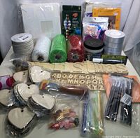 Full lot front view showing multiple crafting supplies including wooden alphabet cutouts, ribbons, beads, and crafting tools.