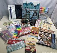 Overview of multiple journaling supplies including markers, sticky notes, pens, stickers, and notebooks