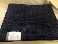 Full view of navy memory foam bath rug showing texture and size