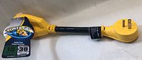 Yellow Camco Power Grip adapter cable with tags. Shows ergonomic grip design and plug ends.