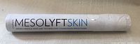 Photo of the Mesolyft skincare tool showing the brand name and product purpose printed on the device.