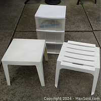 Photo showing three-drawer plastic organizer beside two white plastic outdoor side tables, one with solid top and one with slatted top.