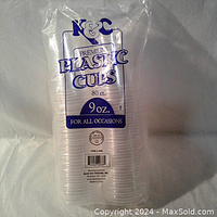Clear stacked set of 80 disposable plastic cups in sealed pack with K&C branding and product info.