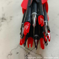Close-up photo showing pointed metal tips and red fletching on fiberglass arrows.