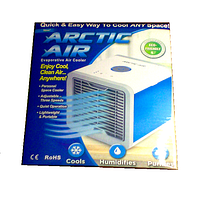 Front view of the boxed Arctic Air evaporative air cooler showing product image and key features such as portability, three adjustable speeds, quiet operation, cooling, humidifying and purifying functions.