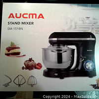 Box of Aucma SM-1518N stand mixer showing product image and included attachments graphics.