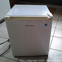 Frontal view of the Hamilton Beach bar fridge showing brand logo and compact size.