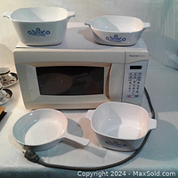 Photo showing compact HomeStyles microwave and four CorningWare blue cornflower dishes on top and in front
