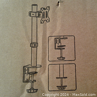 Box exterior showing illustration of mounted desk monitor stand and clamping mechanism.