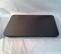 Top view of the folding laptop table showing dark wood grain surface with rounded corners.