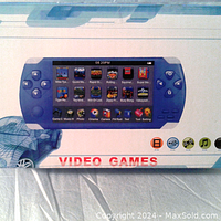 Photo of the handheld console's packaging showing the device with a color screen and various pre-installed games.