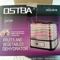 Front of Ostba product box showing 5 tier dehydrator with LCD control, product name, wattage, and use for drying fruits and vegetables.