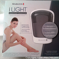 Front of sealed Remington i-Light Essential box showing device image and key features such as Advanced Triggerless Technology and permanent hair reduction claims.