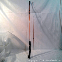 Full view of the 5.6 ft fishing rod showing its length and black handle.