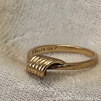Close-up photo of vintage Dason 10K yellow gold ring showing the decorative ribbed loop design on top and interior stamp.
